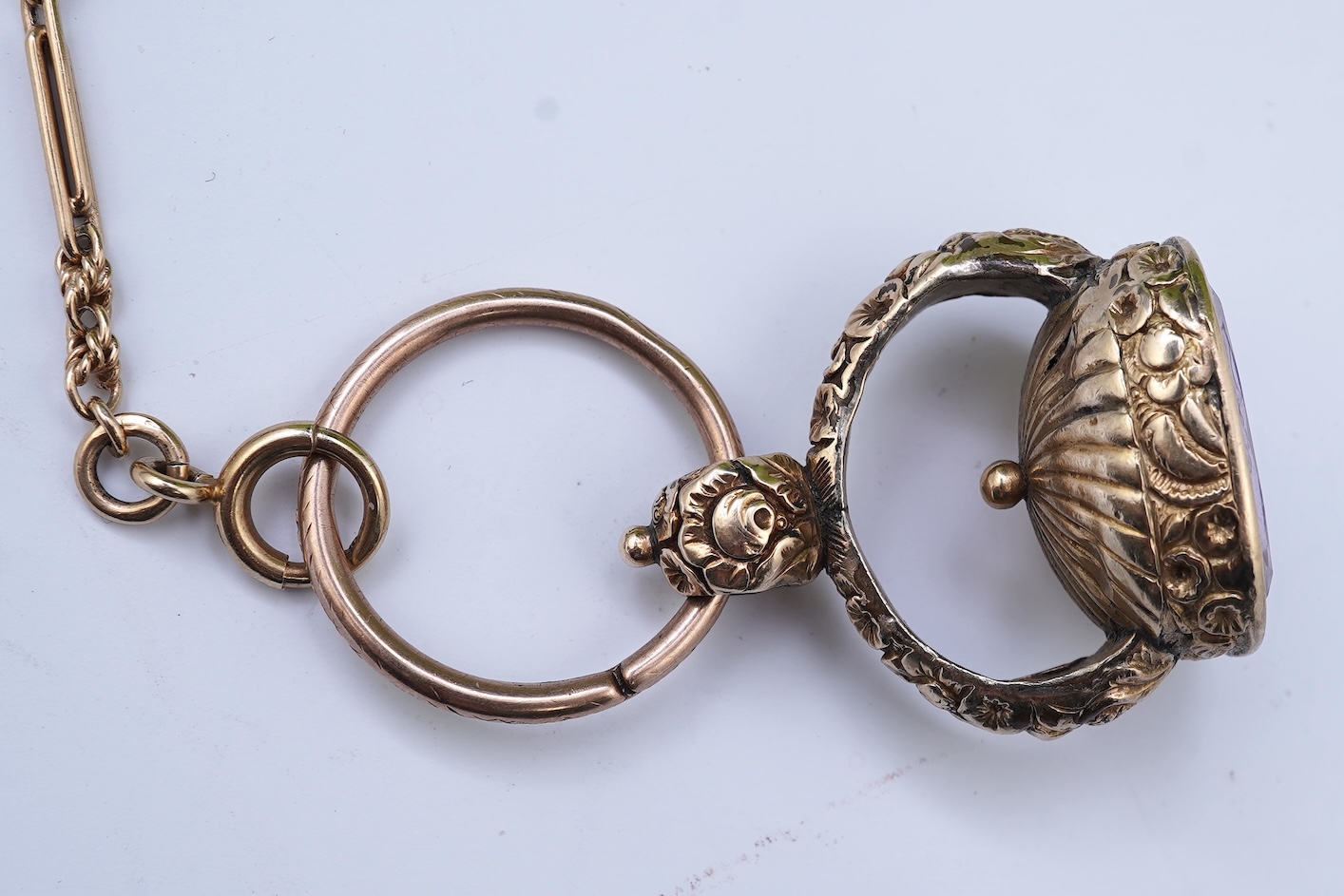 An amethyst fob seal, a gold Albert chain, and a pocket watch